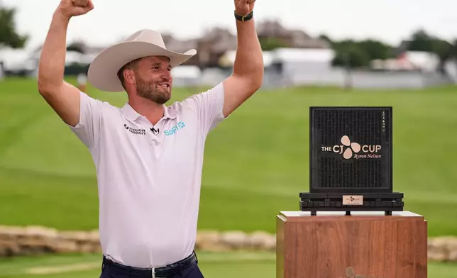 Wyndham Clark celebrates after winning the CJ Cup Byron Nelson golf tournament in McKinney, Texas, Sunday, May 24, 2026. (AP Photo/Tony Gutierrez)