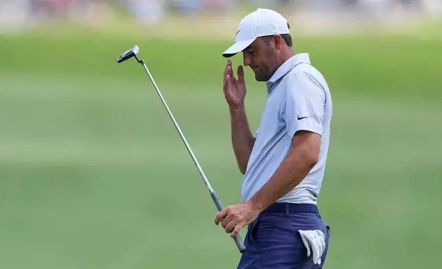 Scottie Scheffler reacts to leaving his putt short on the 10th green during the final round of the CJ Cup Byron Nelson golf tournament in McKinney, Texas, Sunday, May 24, 2026. (AP Photo/Tony Gutierrez)