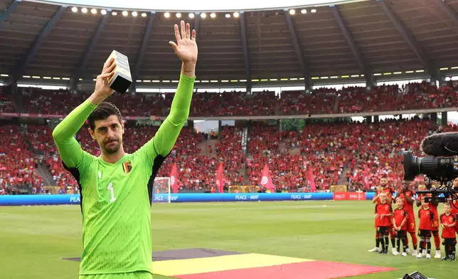 FILE - Belgium's goalkeeper Thibaut Courtois holds a trophy as he celebrates his 100th match during the Euro 2024 group F qualifying soccer match between Belgium and Austria at the King Baudouin Stadium in Brussels, Saturday, June 17, 2023. (AP Photo/Geert Vanden Wijngaert, file)