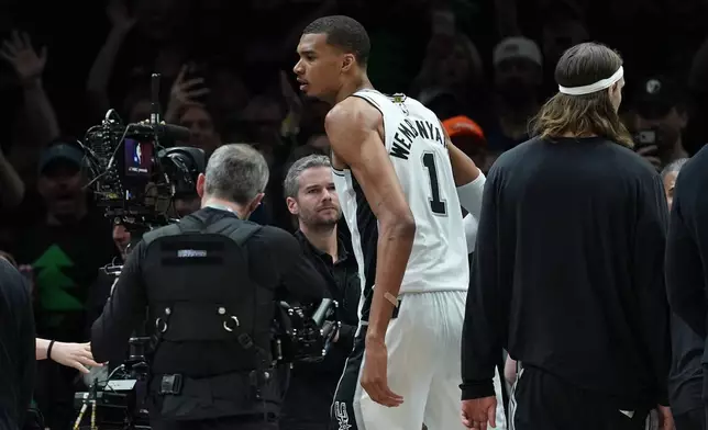 San Antonio Spurs forward Victor Wembanyama (1) reacts after he was ejected for a flagrant foul during the first half of Game 4 of a NBA basketball second-round playoff series against the Minnesota Timberwolves in Minneapolis, Sunday, May 10, 2026. (AP Photo/Abbie Parr)