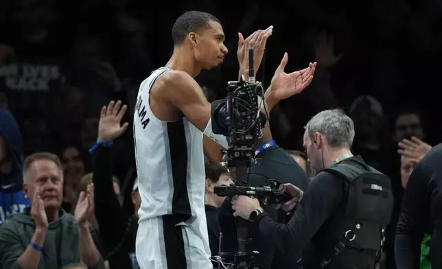 San Antonio Spurs forward Victor Wembanyama (1) reacts after he was ejected for a flagrant foul during the first half of Game 4 of a NBA basketball second-round playoff series against the Minnesota Timberwolves in Minneapolis, Sunday, May 10, 2026. (AP Photo/Abbie Parr)