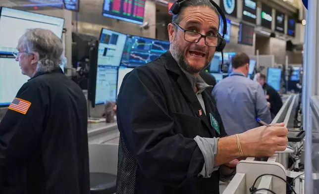 Options trader Chris Dattolo works on the floor of the New York Stock Exchange, Wednesday, May 13, 2026. (AP Photo/Richard Drew)