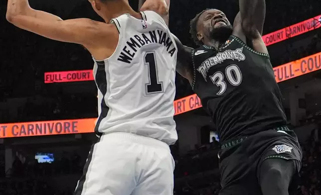 Minnesota Timberwolves forward Julius Randle (30) scores over San Antonio Spurs forward Victor Wembanyama (1) during the first half of Game 3 of a NBA basketball second-round playoff series in Minneapolis, Friday, May 8, 2026. (AP Photo/Abbie Parr)