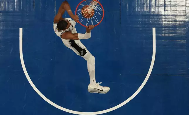 San Antonio Spurs forward Victor Wembanyama (1) dunks during the first half of Game 3 of a NBA basketball second-round playoff series against the Minnesota Timberwolves, Friday, May 8, 2026, in Minneapolis. (AP Photo/Abbie Parr)