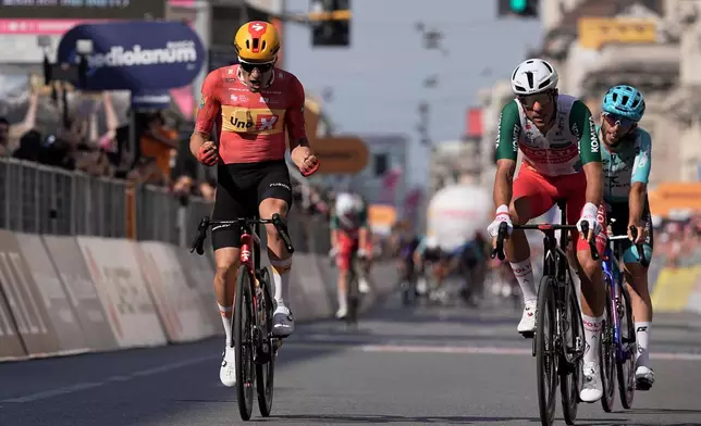 Norway's Fredrik Dversnes Lavik, left, celebrates winning the 15th stage of the Giro d'Italia cycling race, from Voghera to Milan, Italy, Sunday, May 24, 2026. (Marco Alpozzi/LaPresse via AP)