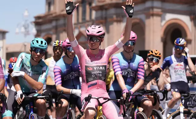 Denmark's Jonas Vingegaard wearing the pink jersey of the race overall leader, waves to fans ahead of the 15th stage of the Giro d'Italia cycling race, from Voghera to Milan, Italy, Sunday, May 24, 2026. (Massimo Paolone/LaPresse via AP)