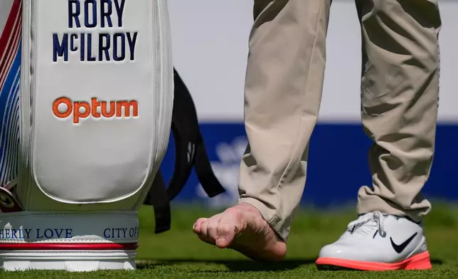 Rory McIlroy, of Northern Ireland, attends to his right foot on the fourth tee during a PGA Championship golf tournament practice round at Aronimink Golf Club, Tuesday, May 12, 2026, in Newtown Square, PA. (AP Photo/Matt Slocum)