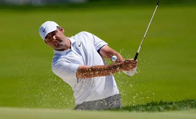 Scottie Scheffler hits from the bunker on the third green during a PGA Championship golf tournament practice round at Aronimink Golf Club, Tuesday, May 12, 2026, in Newtown Square, PA. (AP Photo/Carolyn Kaster)