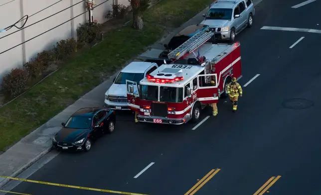Firefighters work at the scene of a chemical tank that overheated at an aerospace plant in Garden Grove, Calif., Friday, May 22, 2026. (AP Photo/Ethan Swope)