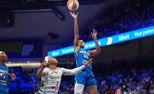 Minnesota Lynx guard Courtney Williams (10) shoots against Minnesota Lynx forward Natasha Howard (1) during the second half of a WNBA basketball game in Arlington, Texas, Thursday, May 14, 2026. (AP Photo/LM Otero)