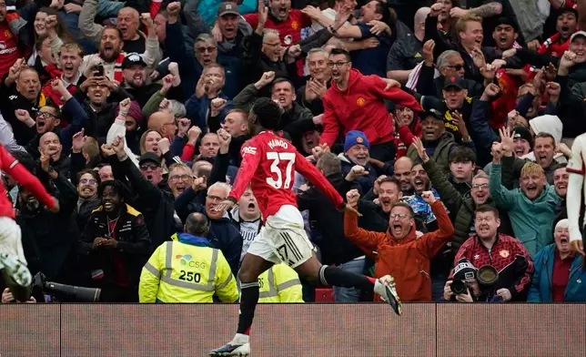 Manchester United's Kobbie Mainoo celebrates after scoring his side's third goal during the English Premier League soccer match between Manchester United and Liverpool in Manchester, England, Sunday, May 3, 2026. (AP Photo/Dave Thompson)