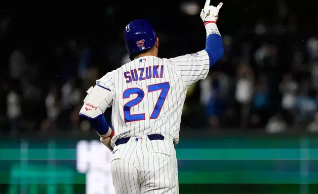 Chicago Cubs' Seiya Suzuki, of Japan, celebrates as he rounds the bases after hitting a three-run home run during the fourth inning of a baseball game against the Cincinnati Reds in Chicago, Monday, May 4, 2026. (AP Photo/Nam Y. Huh)