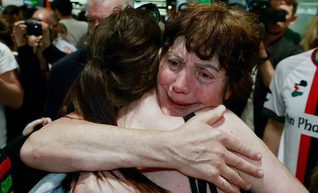 Margaret Connolly, right, embraces her daughter, Katie, at Dublin Airport as twelve Irish citizens who were detained by Israel arrive back in Ireland, Saturday, May 23, 2026. (Conor O Mearain/PA via AP)