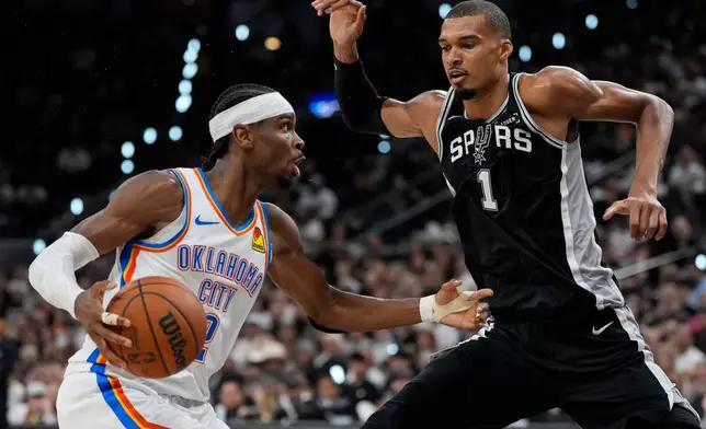 Oklahoma City Thunder guard Shai Gilgeous-Alexander (2) drives against San Antonio Spurs forward Victor Wembanyama (1) in the second half of Game 6 in the Western Conference finals NBA basketball playoffs series, Thursday, May 28, 2026, in San Antonio. (AP Photo/David J. Phillip)