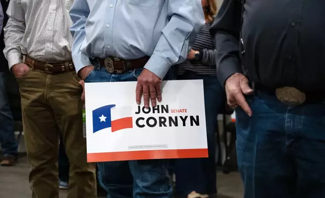 Supporters holds a Sen. John Cornyn, R-Texas, sign during his campaign event in Lubbock, Texas, Tuesday, May 19, 2026. (AP Photo/Annie Rice)