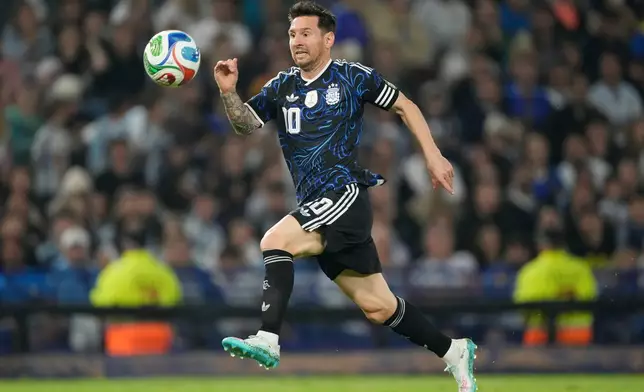 FILE - Argentina's Lionel Messi runs with the ball during a friendly soccer match against Mauritania in Buenos Aires, Argentina, Friday, March 27, 2026. (AP Photo/Gustavo Garello, File)