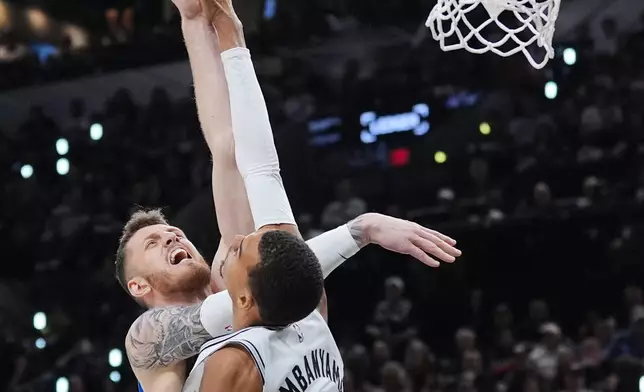 San Antonio Spurs forward Victor Wembanyama (1) blocks a shot by Oklahoma City Thunder center Isaiah Hartenstein during the second half of Game 4 in the Western Conference finals NBA basketball playoffs series in San Antonio, Sunday, May 24, 2026. (AP Photo/Eric Gay)