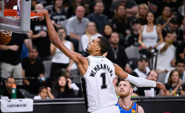 San Antonio Spurs forward Victor Wembanyama (1) scores a basket on the Oklahoma City Thunder during the second half of Game 4 in the Western Conference finals NBA basketball playoffs series in San Antonio, Sunday, May 24, 2026. (AP Photo/Darren Abate)