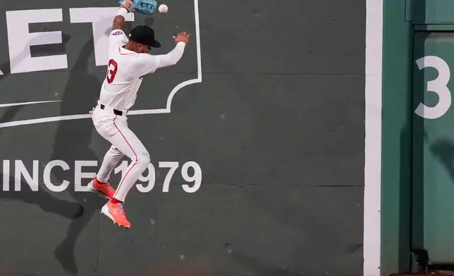 Boston Red Sox's Ceddanne Rafaela misses the catch on a triple by Atlanta Braves' Austin Riley during the sixth inning of a baseball game, Tuesday, May 26, 2026, in Boston. (AP Photo/Charles Krupa)