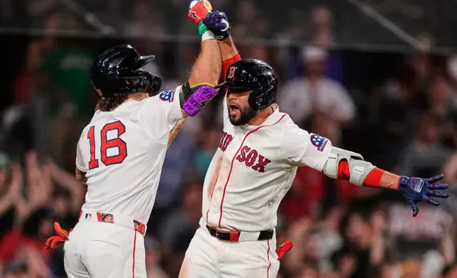 Boston Red Sox's Isiah Kiner-Falefa, right, celebrates with Jarren Duran (16) after his solo home run during the sevent inning of a baseball game against the Atlanta Braves', Tuesday, May 26, 2026, in Boston. (AP Photo/Charles Krupa)