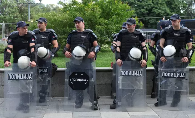 Riot policemen stand by an enclosure for government supporters before the first big rally of the year led by Serbia's protesting university students who are pushing for major political changes in the Balkan country run by President Aleksandar Vucic, in Belgrade, Serbia, Saturday, May. 23, 2026. (AP Photo/Armin Durgut)