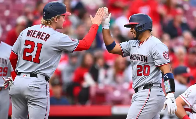 Washington Nationals' Keibert Ruiz, right, celebrates his two-run home run with Joey Wiemer, left, during the second inning of a baseball game against the Cincinnati Reds in Cincinnati, Wednesday, May 13, 2026. (AP Photo/Ben Jackson)