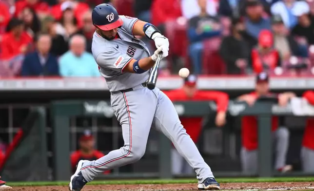 Washington Nationals' Keibert Ruiz (20) hits a two-run home run during the second inning of a baseball game against the Cincinnati Reds in Cincinnati, Wednesday, May 13, 2026. (AP Photo/Ben Jackson)