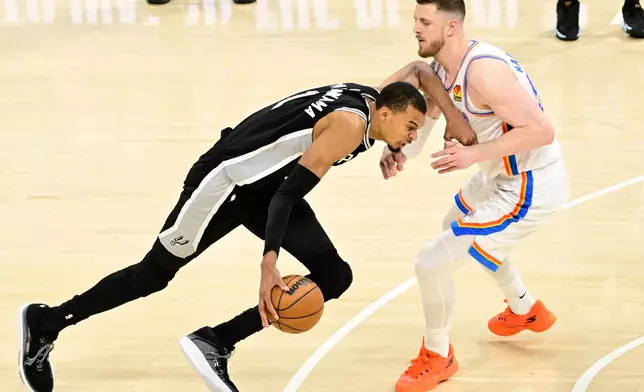San Antonio Spurs forward Victor Wembanyama (1) moves against the Oklahoma City Thunder in the second half of Game 5 in the Western Conference finals NBA basketball playoffs series, Tuesday, May 26, 2026, in Oklahoma City. (AP Photo/Gerald Leong)