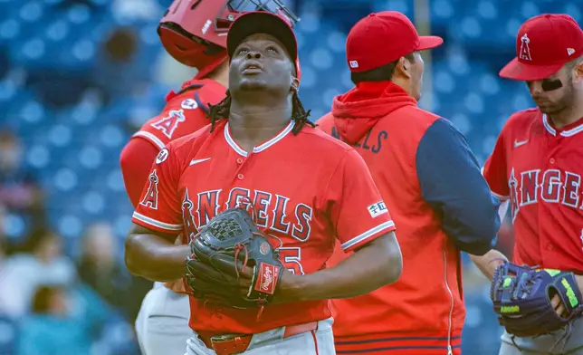 Los Angeles Angels relief pitcher Jose Fermin reacts after being removed by manager Kurt Suzuki during the third inning of a baseball game against the Cleveland Guardians, Monday, May 11, 2026, in Cleveland. (AP Photo/Phil Long)