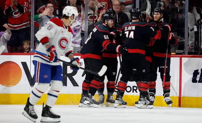 Carolina Hurricanes celebrate a goal by Eric Robinson during the first period in Game 2 of the Eastern Conference finals NHL hockey Stanley Cup playoff series against the Montreal Canadiens in Raleigh, N.C., Saturday, May 23, 2026. (AP Photo/Karl DeBlaker)