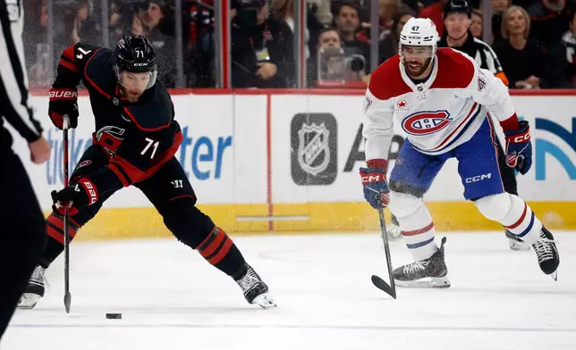 Carolina Hurricanes' Taylor Hall (71) controls the puck with Montreal Canadiens' Jayden Struble (47) nearby during the first period in Game 2 of the Eastern Conference finals NHL hockey Stanley Cup playoff series in Raleigh, N.C., Saturday, May 23, 2026. (AP Photo/Karl DeBlaker)
