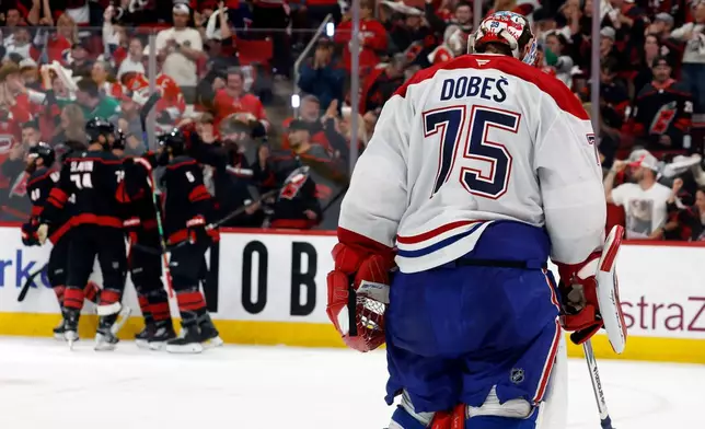 Carolina Hurricanes players celebrate after a goal by Nikolaj Ehlers as Montreal Canadiens goaltender Jakub Dobes (75) returns to the net during the second period in Game 2 of the Eastern Conference final NHL hockey Stanley Cup playoff series in Raleigh, N.C., Saturday, May 23, 2026. (AP Photo/Karl DeBlaker)