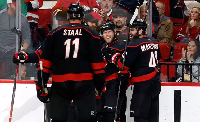 Carolina Hurricanes' Nikolaj Ehlers, second from right, celebrates after his goal against the Montreal Canadiens with teammates during the second period in Game 2 of the Eastern Conference final NHL hockey Stanley Cup playoff series in Raleigh, N.C., Saturday, May 23, 2026. (AP Photo/Karl DeBlaker)