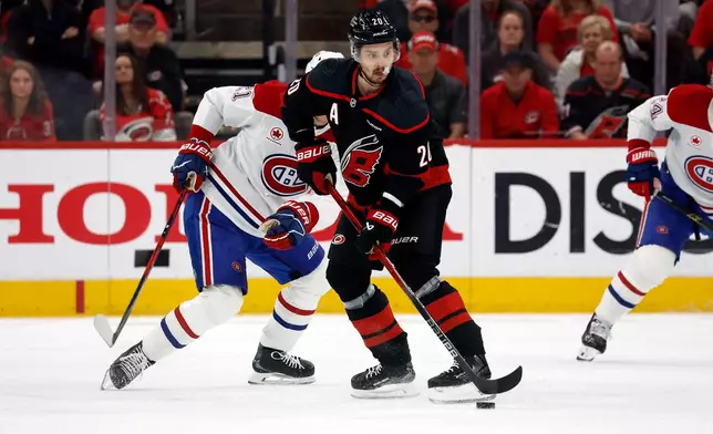 Carolina Hurricanes' Sebastian Aho (20) controls the puck against the Montreal Canadiens during the first period in Game 2 of the Eastern Conference finals NHL hockey Stanley Cup playoff series in Raleigh, N.C., Saturday, May 23, 2026. (AP Photo/Karl DeBlaker)