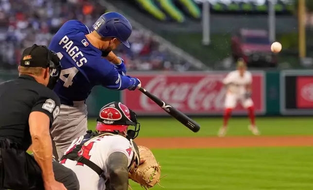 Los Angeles Dodgers' Andy Pages, center, hits a three-run home run as Los Angeles Angels catcher Logan O'Hoppe, right, and home plate umpire Jim Wolf watch during the fourth inning of a baseball game Friday, May 15, 2026, in Anaheim, Calif. (AP Photo/Mark J. Terrill)