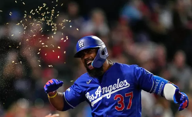 Los Angeles Dodgers' Teoscar Hernández has seeds thrown at him after hitting a two-run home run during the sixth inning of a baseball game against the Los Angeles Angels, Friday, May 15, 2026, in Anaheim, Calif. (AP Photo/Mark J. Terrill)