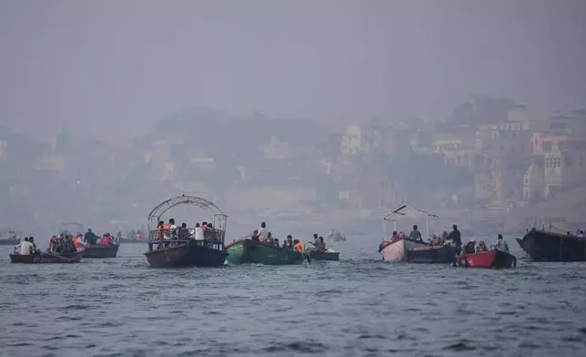 FILE - Tourists take a boat ride early morning in the Ganges river in Varanasi, India, March.16, 2026. (AP Photo/Channi Anand, File)
