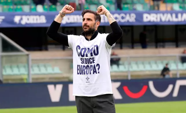 Como's coach Cesc Fabregas wears a jersey reading " Como means Europe? " as he celebrates with fans after his team clinched a berth in the UEFA competitions, at the end of the Serie A soccer match between Hellas Verona and Como, in Verona, Italy, Sunday, May 10, 2026. (Paola Garbuio/LaPresse via AP)