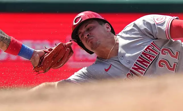 Cincinnati Reds' JJ Bleday slides safely into third ahead of the tag by Philadelphia Phillies third baseman Edmundo Sosa during the seventh inning of a baseball game, Wednesday, May 20, 2026, in Philadelphia. (AP Photo/Matt Rourke)