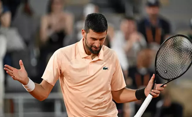 Novak Djokovic of Serbia celebrates after winning the first round men's singles tennis match against against Giovanni Mpetshi Perricard of France at the French Open tennis tournament in Paris, Sunday, May 24, 2026. (AP Photo/Emma Da Silva)