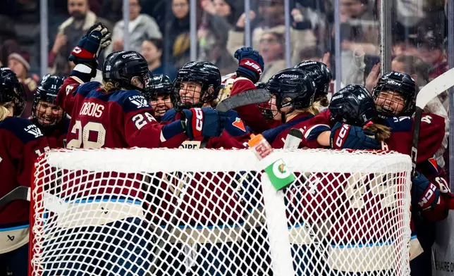 Montreal Victoire teammates celebrate after defeating the Minnesota Frost in PWHL playoff hockey action in Laval, Que., on Tuesday, May 12, 2026. (Christopher Katsarov/The Canadian Press via AP)