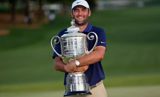 FILE - Scottie Scheffler holds the Wanamaker trophy after winning the PGA Championship golf tournament at the Quail Hollow Club, Sunday, May 18, 2025, in Charlotte, N.C. (AP Photo/David J. Phillip, File)