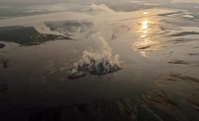 Smoke billows from the crater of the "mud volcano" that was caused by a gas exploration accident in 2006, in Sidoarjo, East Java, Indonesia, Friday, May 29, 2026. (AP Photo/Trisnadi)