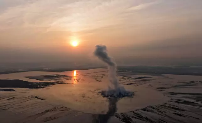 Smoke billows from the crater of the "mud volcano" that was caused by a gas exploration accident in 2006, in Sidoarjo, East Java, Indonesia, Friday, May 29, 2026. (AP Photo/Trisnadi)