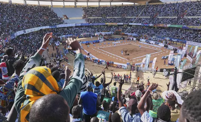 Fans attend a wrestling competition at the National Arena in Dakar, Senegal, Sunday, April 5, 2026. (AP Photo/Misper Apawu)