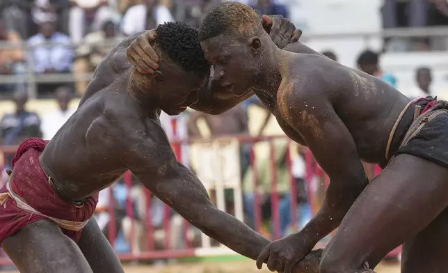 Wrestlers compete at the national wrestling arena in Dakar, Senegal, Sunday, April 5, 2026. (AP Photo/Misper Apawu)