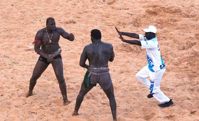 Wrestlers compete at the national wrestling arena in Dakar, Senegal, Sunday, April 5, 2026. (AP Photo/Misper Apawu)
