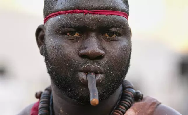 A wrestler waits to compete at the national wrestling arena in Dakar, Senegal, Sunday, March 29, 2026. (AP Photo/Misper Apawu)