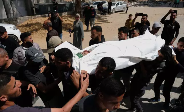 Mourners carry the body of Mohammad Odeh, whom Israel says was a leader of Hamas Qassam Brigades, a day after he was killed in an Israeli airstrike, during his funeral in Gaza City, Wednesday, May 27, 2026. (AP Photo/Jehad Alshrafi)