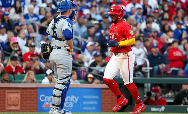 Los Angeles Dodgers catcher Will Smith stands near as St. Louis Cardinals' Iván Herrera, right, scores a run on a balk during the first inning of a baseball game Friday, May 1, 2026, in St. Louis. (AP Photo/Scott Kane